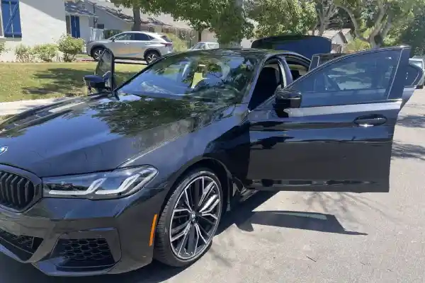 A BMW convertible on the street gets mobile car detailing from Armando King Mobile Detailing.
