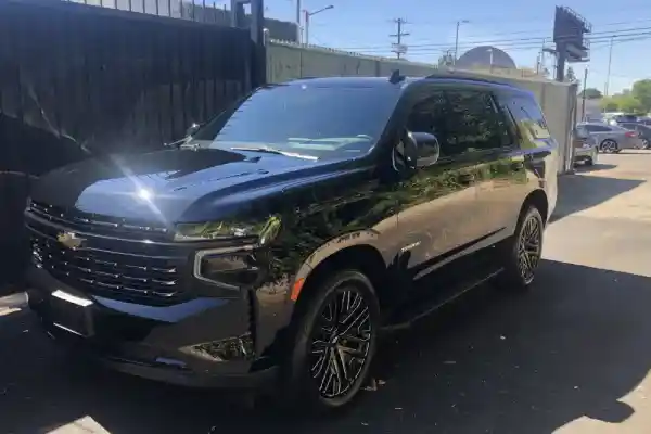 A black SUV at a building entrance benefits from mobile auto detailing San Fernando Valley by Armando King Mobile Detailing.