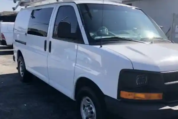 A white van at a business location is cleaned by Armando King Mobile Detailing with mobile car detailing.