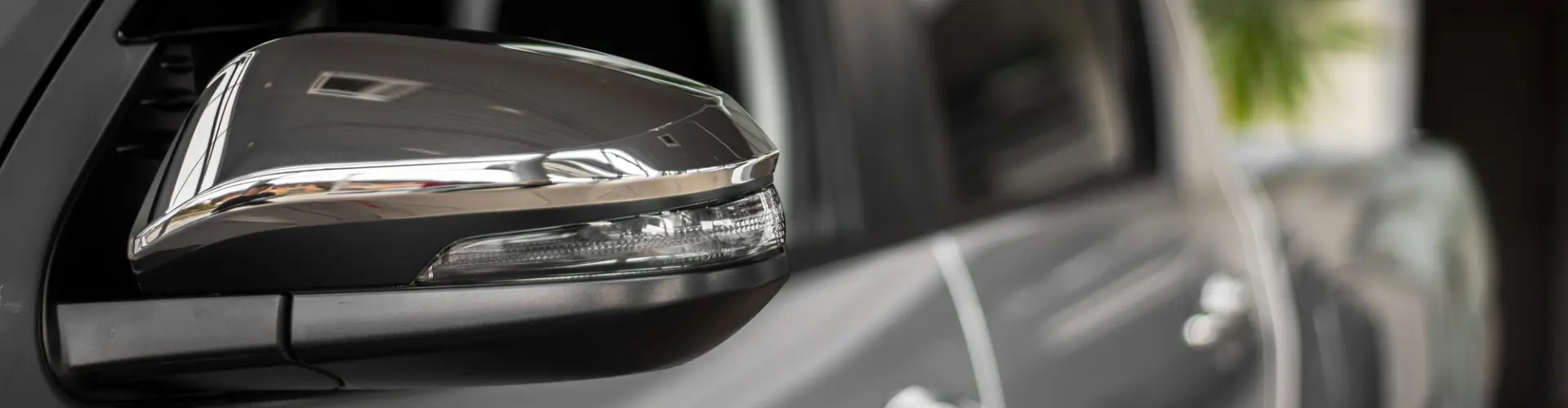 Armando King Mobile Detailing uses mobile car detailing to clean a car mirror reflection at home.