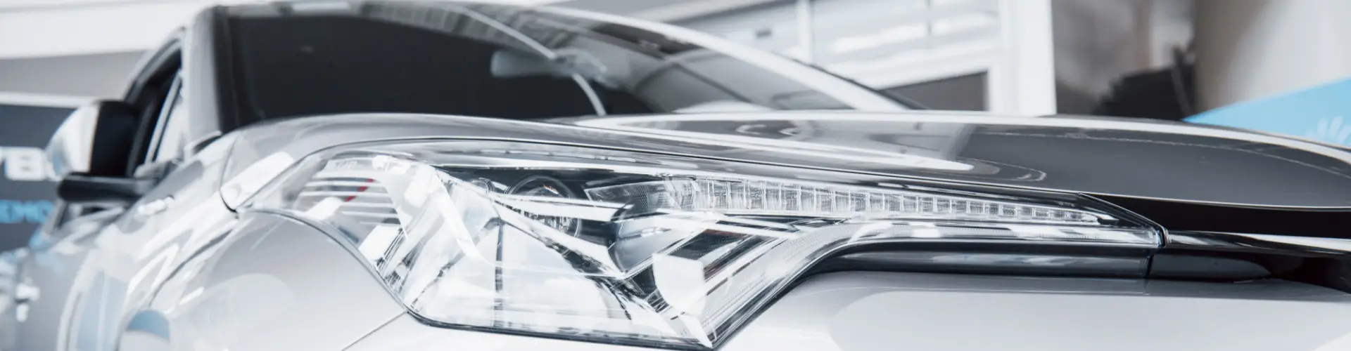 With mobile car detailing service Los Angeles, Armando King Mobile Detailing brightens a car headlight on the driveway.