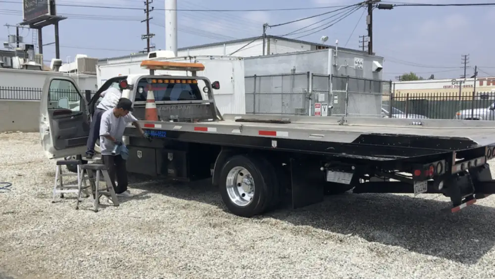 While a man works on the truck, Armando King Mobile Detailing completes mobile car detailing nearby.