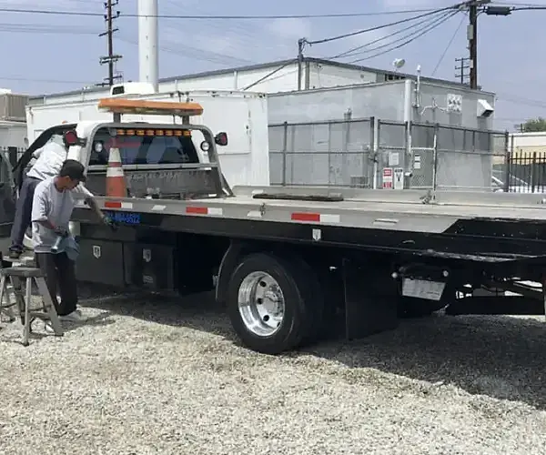 While a man works on the truck, Armando King Mobile Detailing completes mobile car detailing nearby.