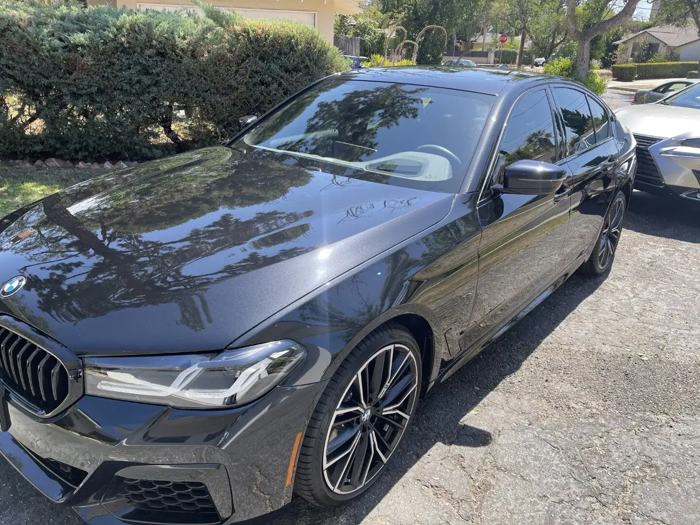 A black BMW at a house in Porter Ranch is treated by Armando King Mobile Detailing with mobile car detailing.