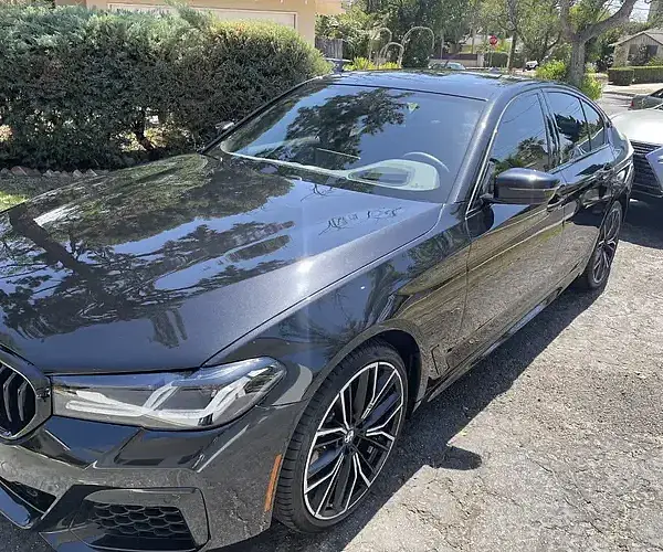 A black BMW at a house in Porter Ranch is treated by Armando King Mobile Detailing with mobile car detailing.