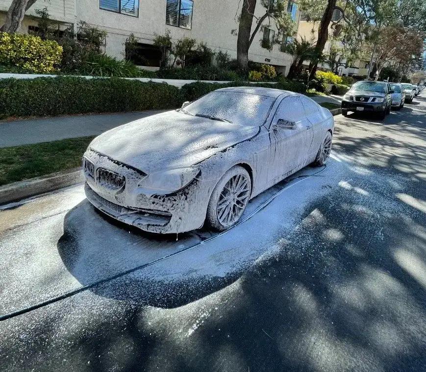 A snow covered car on the street is revived by Armando King Mobile Detailing with mobile auto detailing San Fernando Valley.