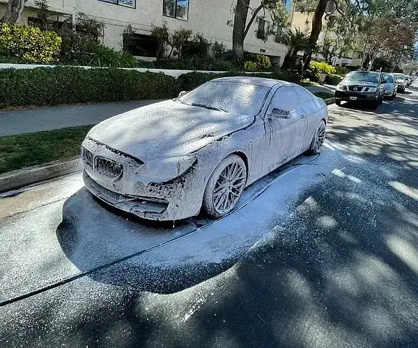 A snow covered car on the street is revived by Armando King Mobile Detailing with mobile auto detailing San Fernando Valley.